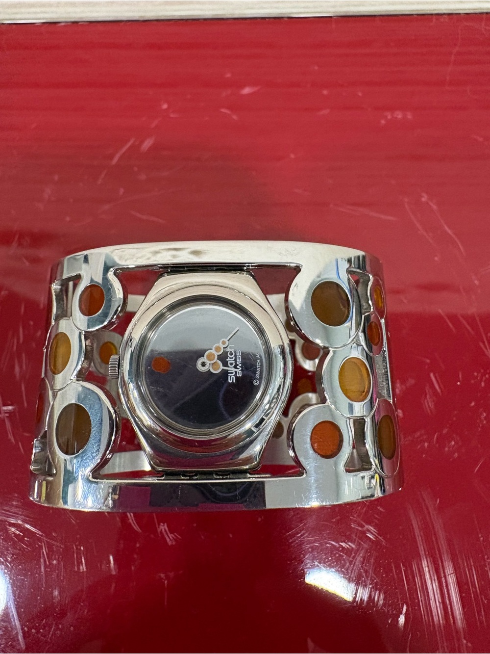 Swatch Silver Cuff Watch with Orange Accents